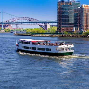 Tour Boat traversing the East River toward Astoria, Queens, New York City